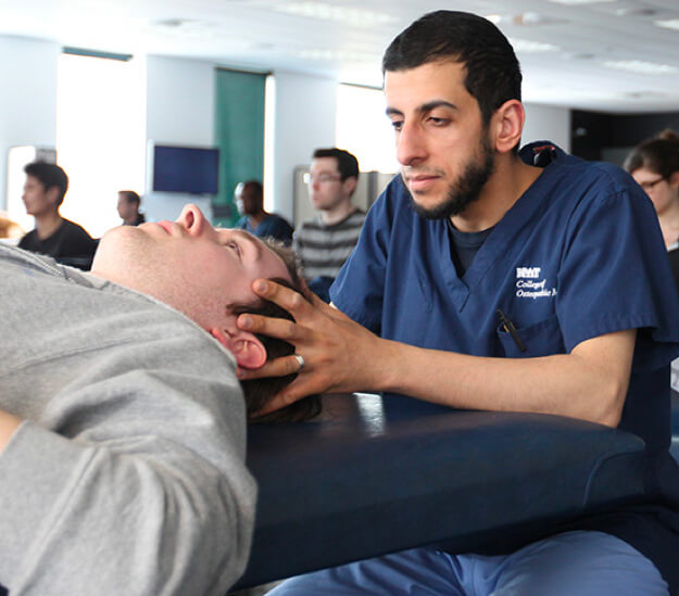 Image of a student doctor practicing osteopathic manipulative medicine at the College of Osteopathic Medicine