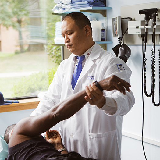 Doctor performing osteopathic manipulative treatment on a patient